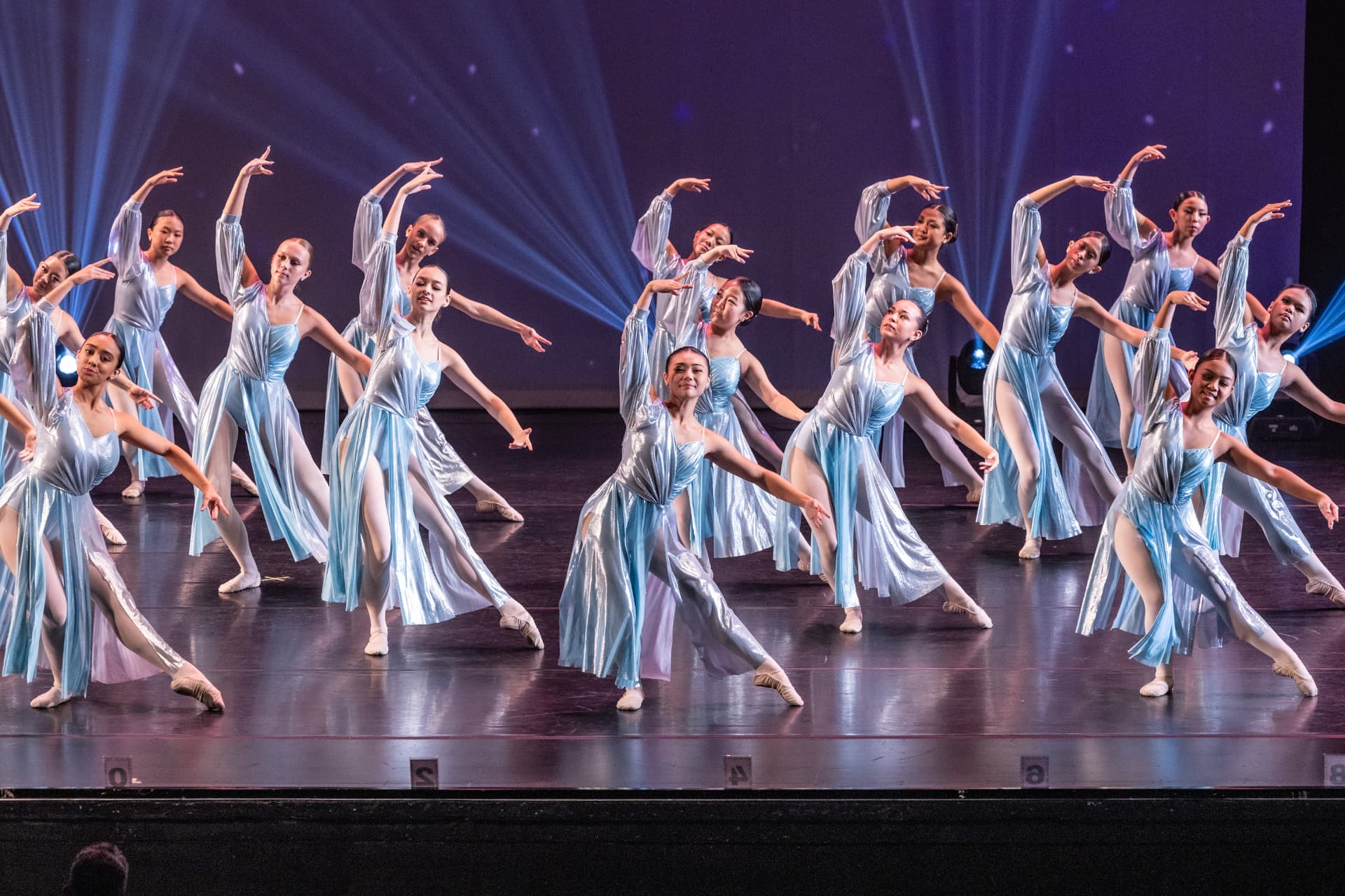 PDD dancers in pale blue lyrical costumes performing on stage